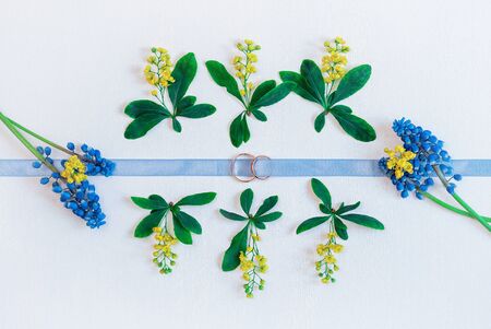 Wedding background with rings and flowers muscari. Vintage toning.の写真素材
