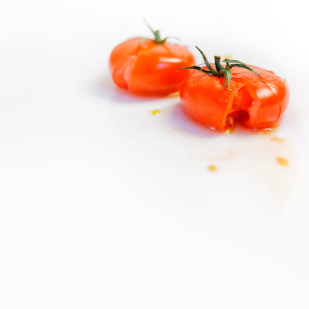 Smashed tomatoes on a white table aka fresh ketchupの写真素材