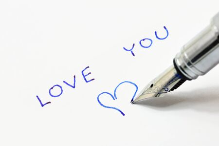 Declaration of love written in ink pen on white paperの写真素材