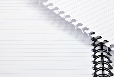 White notepad with black spiral and torn paperの写真素材