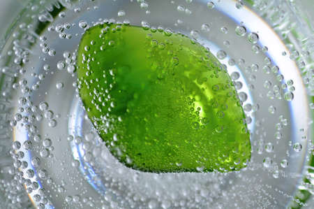 Detail of a small green gemstone in the sparkling waterの写真素材