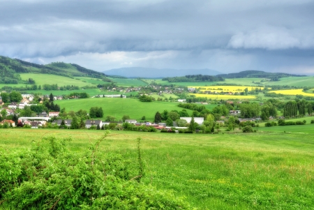 Small town Kdyne in green meadows before the stormの写真素材