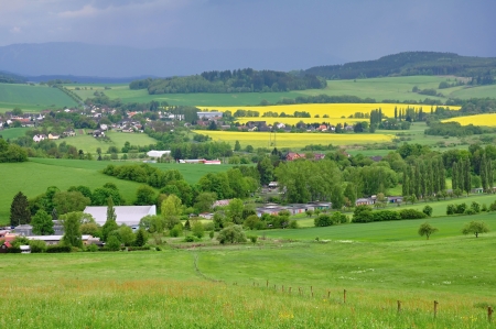 Small town Kdyne in green meadows before the stormの写真素材