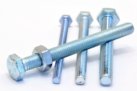 Several galvanized steel bolts and nuts on a white backgroundの写真素材