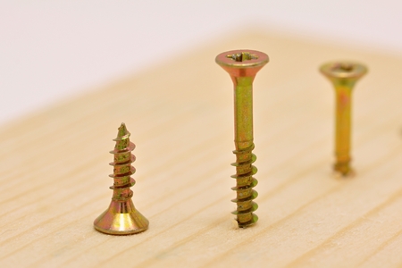 One screw partially screwed into the wooden planksの写真素材