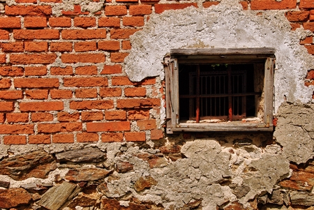 Old wooden window with lattic in old brick buildingの写真素材