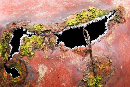Detail of old rusted sheet metal pots with moss