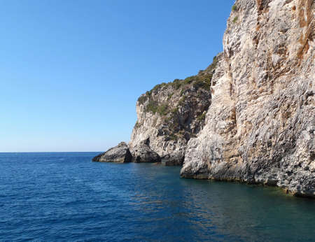 The sun, the rocks of the coast and the beautiful seaの写真素材