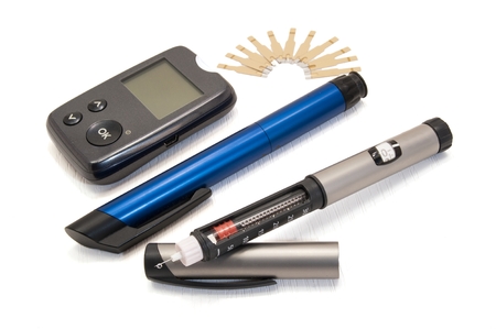 Glucometer and insulin pens for diabetics on a white backgroundの写真素材
