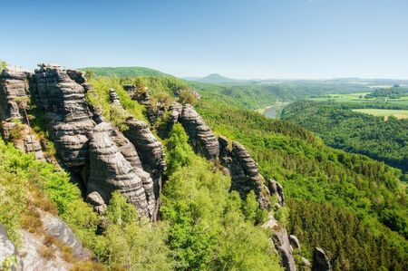 Sandstone rocks, forests and blue sky in the Czech Switzerlandの写真素材