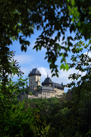 Gothic royal castle Karlstejn in green forest window during summer, Central Bohemia, Czech republic, Europeのeditorial素材