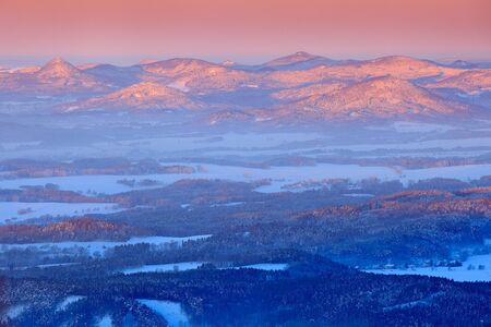 Blue winter landscape, birch tree forest with snow, ice and rime. Pink morning light before sunrise. Winter twilight, cold nature in forest. Orlicke hory, Czech republic. Mountain landscape with trees.の写真素材