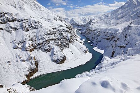 Indus river in Hemis NP, Ladak, India. River with snow during winter, Himalayas. Mountain landscape in India wild nature. Sunny day with snow in the valley, blue sky with white clouds.の写真素材