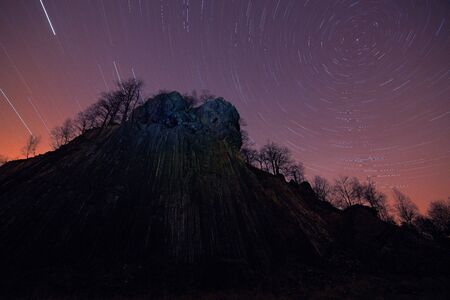 Basalt pole stone hill during the night with stars sky. Zlaty vrch in  Ceske Svycarsko, Czech...