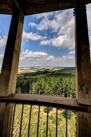 View through the frame of the wooden outlook tower to the woodsの写真素材