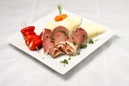 Melon pieces with bacon and filled red paprikasの写真素材