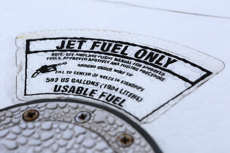 Rain wet Jet fuel only placard on the aircraft wing