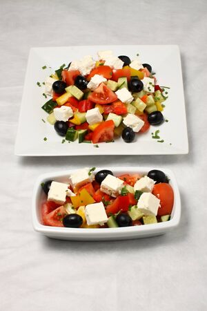 Square plate and rectangle dish with vegetable saladの写真素材