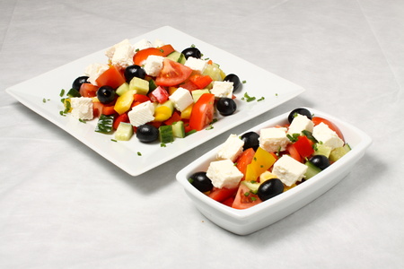 White plate and small saucer full of saladの写真素材