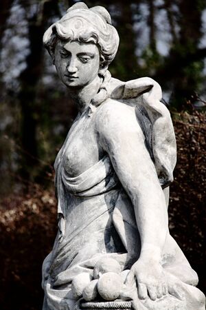 Renaissance sculpure of the almost naked women with fruitsの写真素材