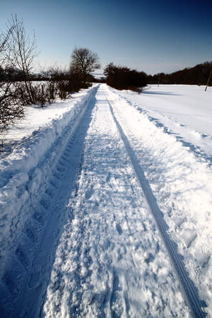 Rural road in the deep snow furrowの写真素材