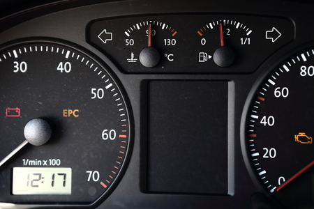 Black dashboard with clock, revolution counter, spedometer and smaller gaugesの写真素材