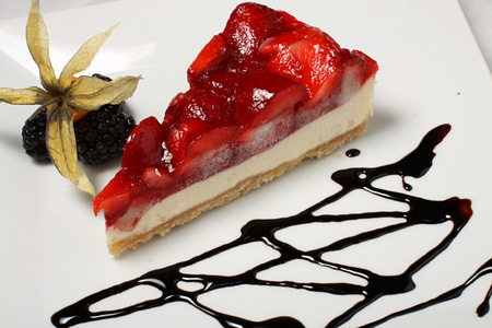 Red strawberry cake with chocolate and black raspberriesの写真素材