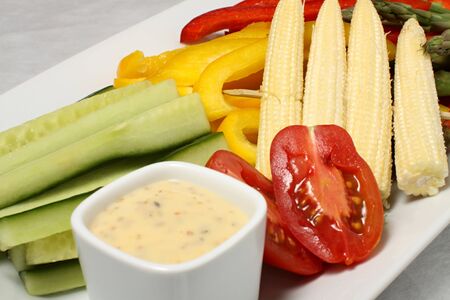 Cucumber, corn and tomato detail with french sauceの写真素材