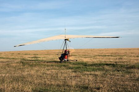 The motor hang-glider on the runway at sunsetの写真素材