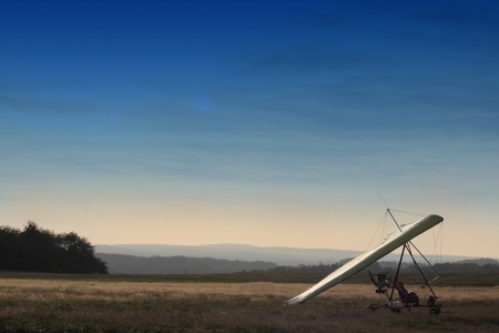 The motor hang-glider on the runway at sunsetの写真素材