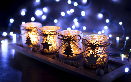 Advent, four candles decorated Christmas tree on a background of lightsの写真素材