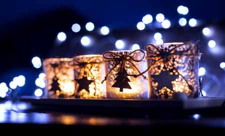 Advent, four candles decorated Christmas tree on a background of lights in exteriorの写真素材