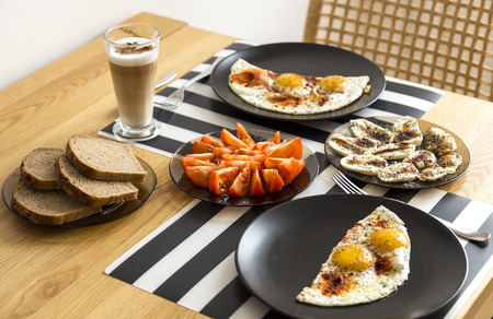 modest home breakfast bread, eggs, tomatoes, mozzarella, latte