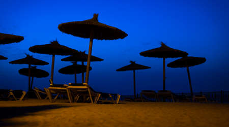 beach umbrellas on the beach before sunrise, nobody, silenceの写真素材