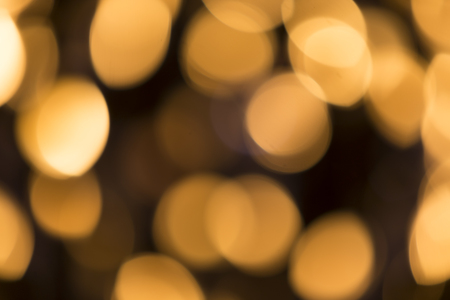 Abstract glittering lights, gold background, a real foto in the blurの写真素材