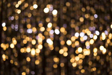 Abstract glittering lights, gold background, a real foto in the blurの写真素材