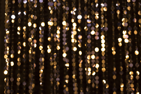 Abstract glittering lights, gold background, a real foto in the blurの写真素材