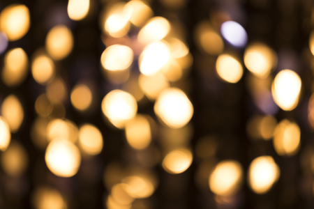 Abstract glittering lights, gold background, a real foto in the blurの写真素材