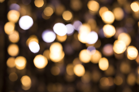 Abstract glittering lights, gold background, a real foto in the blurの写真素材