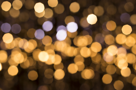 Abstract glittering lights, gold background, a real foto in the blurの写真素材