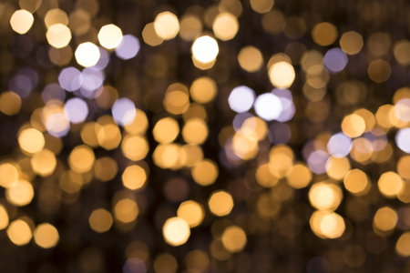 Abstract glittering lights, gold background, a real foto in the blurの写真素材