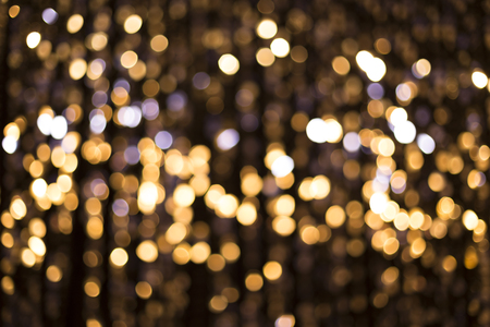 Abstract glittering lights, gold background, a real foto in the blurの写真素材