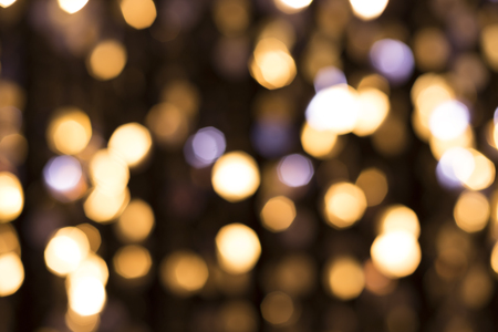 Abstract glittering lights, gold background, a real foto in the blurの写真素材