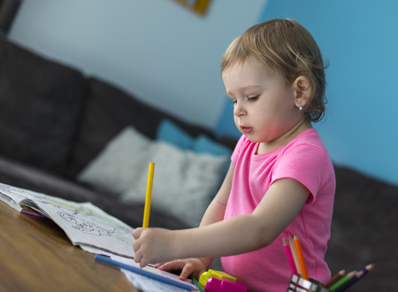 Cute little preschooler child drawing at homeの写真素材