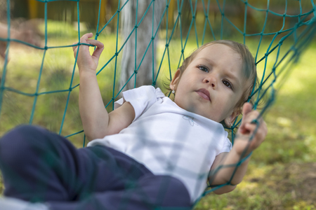 baby relaxing in the hammock on the gardenの写真素材