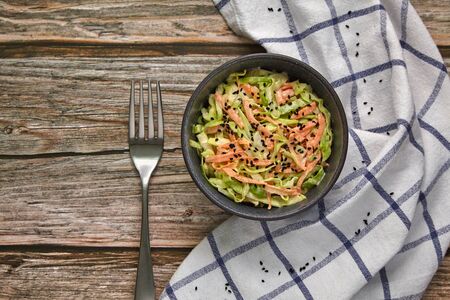 White cabbage and carrot salad with black caraway seeds and mayonnaise and lemon dressingの写真素材
