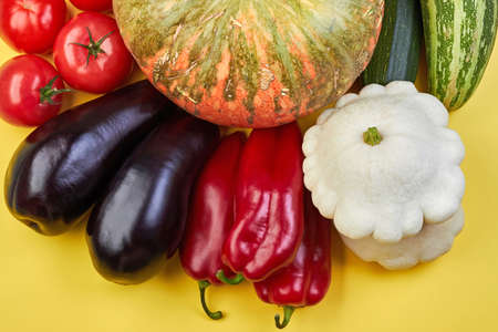 Fresh organic vegetables on a yellow background. Healthy food concept