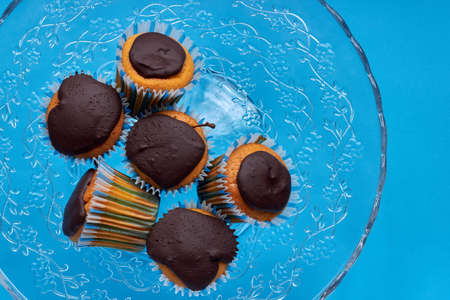 Muffins with chocolate glaze on a glass dish