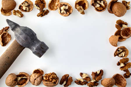 A frame made of chopped walnuts and a hammerの写真素材