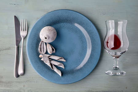 Blue plate with glass of wine and exotic spices and fruits on light blue wooden table. Flat layの写真素材